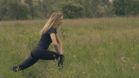 Woman Stretching And Warming-Up Before Running. Girl Limbering-Up And Stretching Legs And Hands.