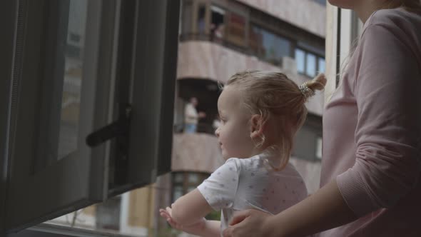 Mum with baby daughter joining applause for doctors during Covid-19 pandemic