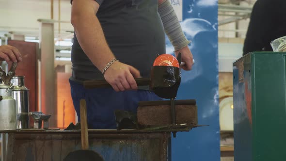 Glass Blower Shaping a Bubble of Melted Glass on a Rod