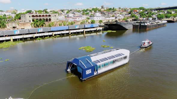 View of interceptor 004 collecting garbage in the Ozama River, Santo Domingo