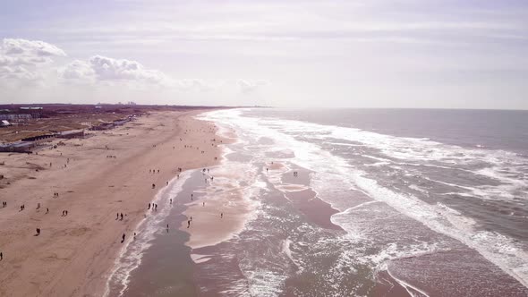 Aerial View Along Sea Waves Along Katwijk aan Zee Beach Coastline In South Holland On Bright Sunny D