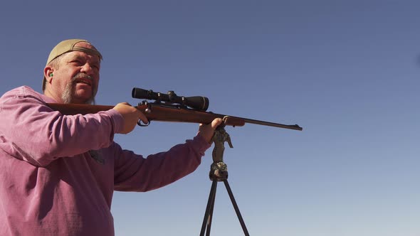 A man uses a bolt action rifle for target practice before deer hunting on the Colorado range.  A spe