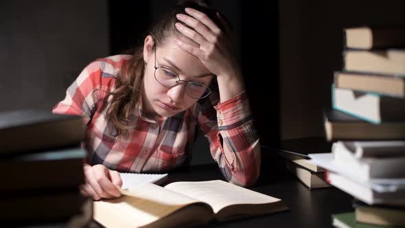 girl was tired of studying, took off glasses, rubbed eyes and lay down to rest