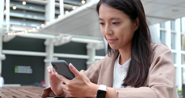 Business Woman Use of Smart Phone at Outdoor Cafe