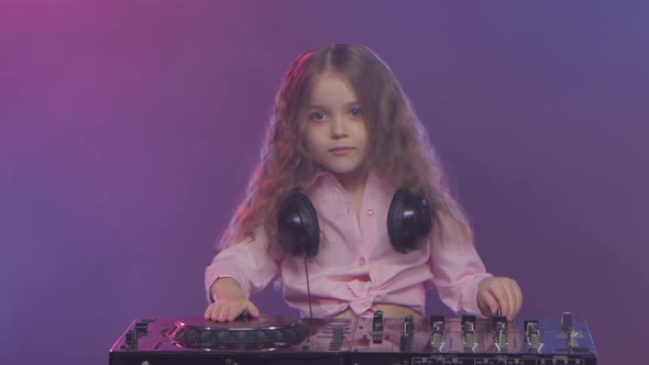 Little Girl Dj Playing on Vinyl. Colored Smoke on Background alt