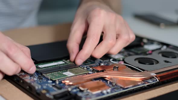Unrecognizable Engineer Pulls Out the RAM