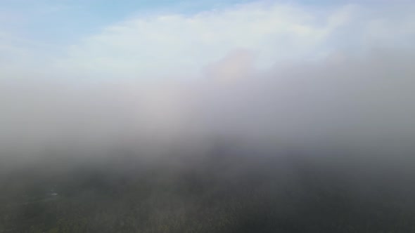 Aerial fly through white fog cloud