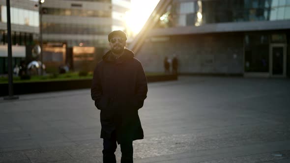 Citydweller in Downtown in Morning Portrait of Stylish Person Against Sun in Autumn or Spring