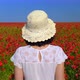 Female Back with a Hat in a Red Poppy Field. White Clothes. Blue Sky. Close up - VideoHive Item for Sale