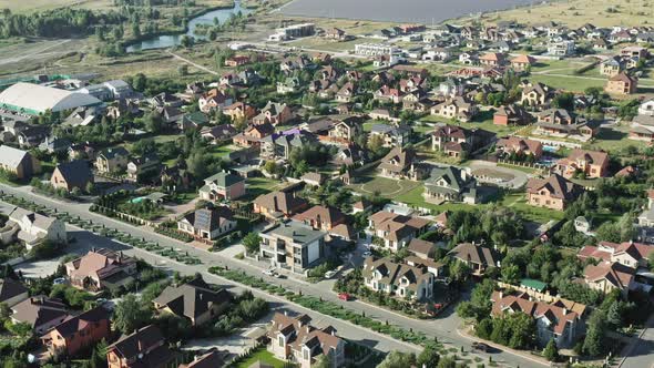 Establishing Shot of Cottage Township with Solar Photovoltaic Panels Arrays on the Roofs