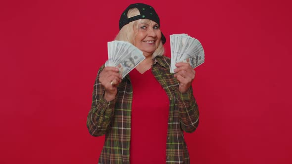 Rich Pleased Boss Senior Woman Waving Money Dollar Cash Banknotes Like a Fan Success Business Career