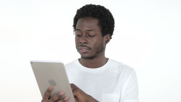 African Man Browsing Interne on Tablet, White Background