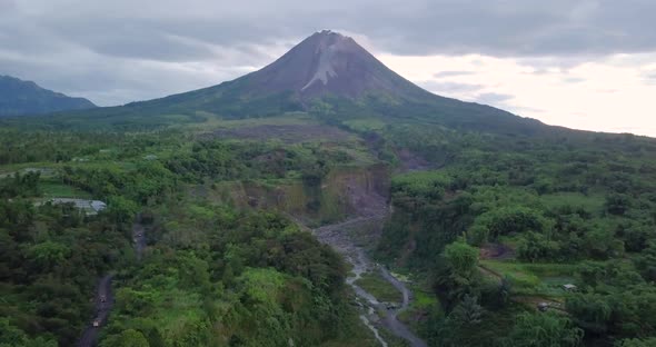 Aerial view of showing slope of Merapi Volcano in Indonesia and dried lava path during clouds at sky