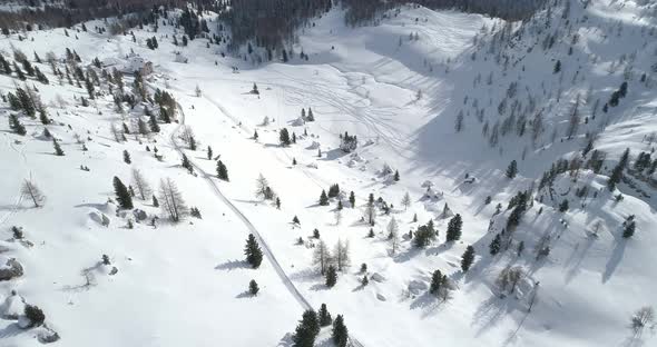 Forward Aerial Over Snowy Plain and Snow Valley with Ski Tracks at Cinque Torri Mounts