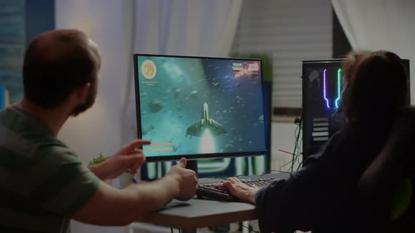 Gaming Over for Nervous Pro Couple Gamers Playing Space Shooter
