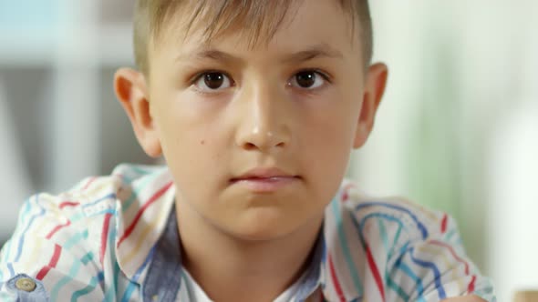 Little Caucasian Boy Posing with Easter Eggs on Hay alt