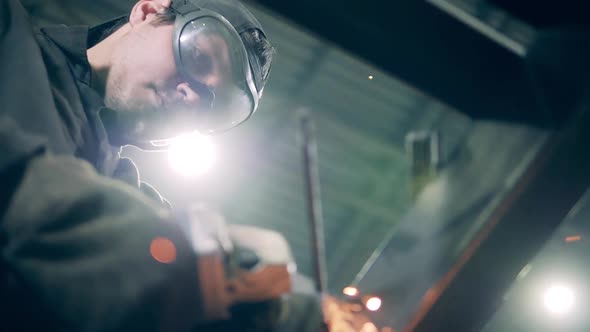 Craftsman Is Using a Saw To Cut Steel