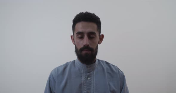Middle eastern muslim man opens his eyes