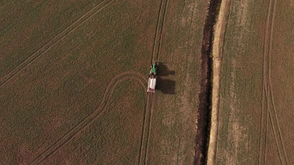 Aerial View Of A Tractor Driving Across The Field