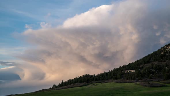 Time lapse of clouds moving behind Bald Mountain at sunset