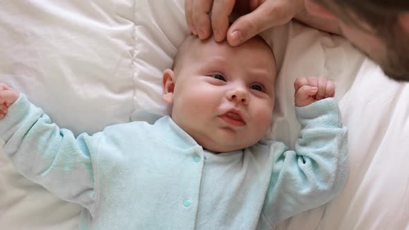 Newborn Baby Smiling and Looking Up at Father