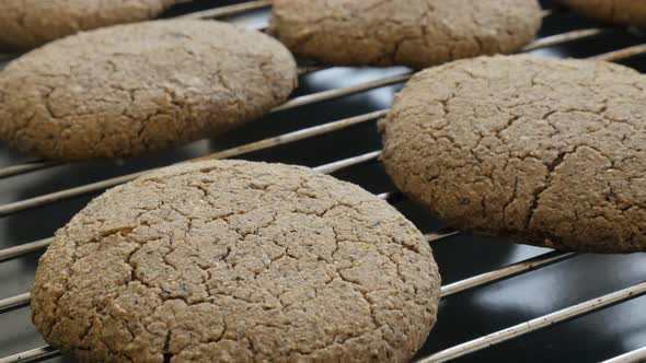 Close-up of whole wheat bread product on baking rack 4K 2160p 30fps UltraHD tilting footage - Oven b