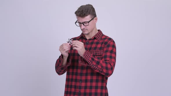 Happy Bearded Hipster Man Playing with Fidget Spinner