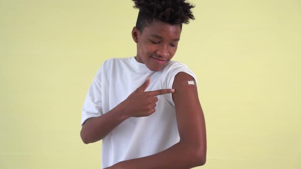 African American Teenager Showing COVID19 Vaccine Bandage Merrily