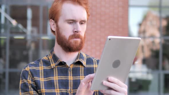 Redhead Beard Young Man Using Tablet Outdoor