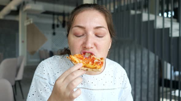 Young Woman Eats Tasty Pizza Enjoying in Cafe