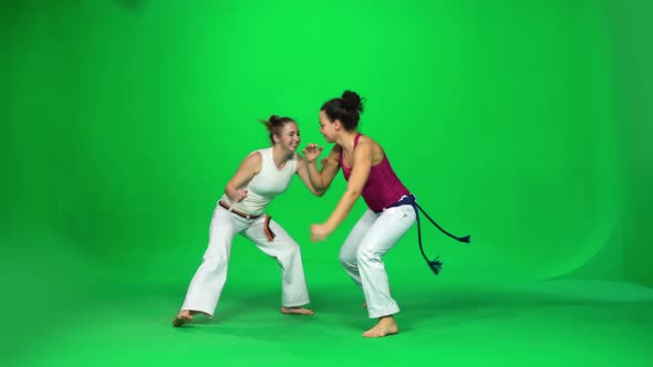 Two Woman Are Practicing Capoeira on Chroma Key Studio. Slow Motion.