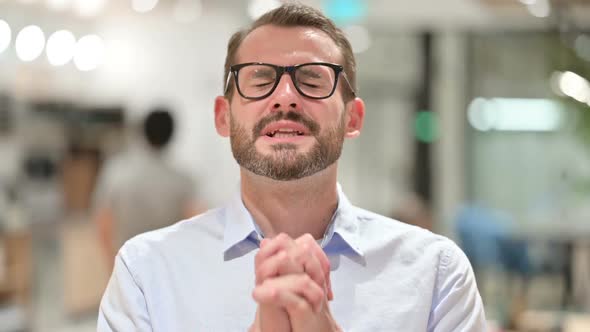 Portrait of Hopeful Businessman Praying Forgiveness alt