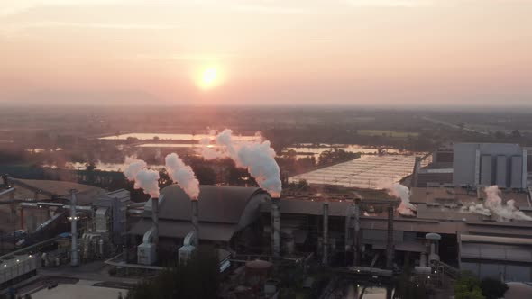 Aerial view Drone shot of flying around toxic chimneys tubing. Air Pollutants, Industrial zone.