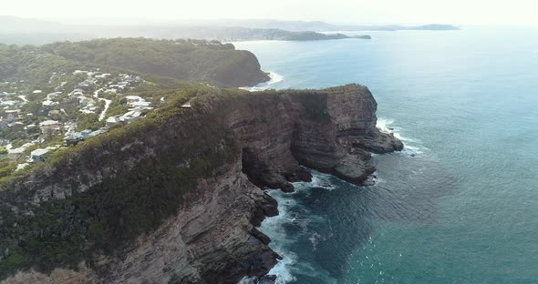 Tracking aerial shot of the East Australian coastline.