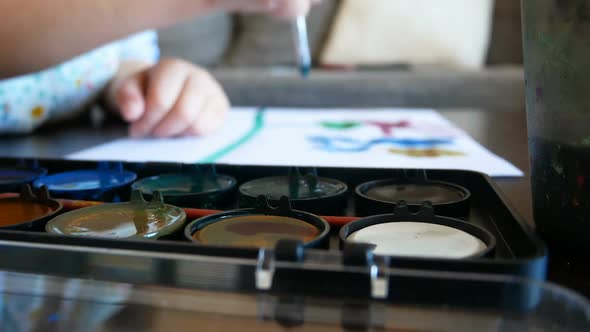 Small Kid Painting With Watercolor At Home Close Up