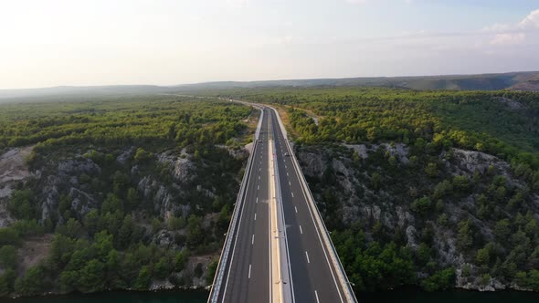 Aerial view on road. Highway through  mountain valley. View from a drone.