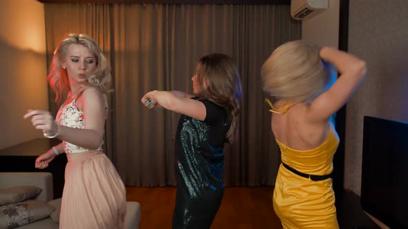 Three Happy Girls Dancing Together in House at Party