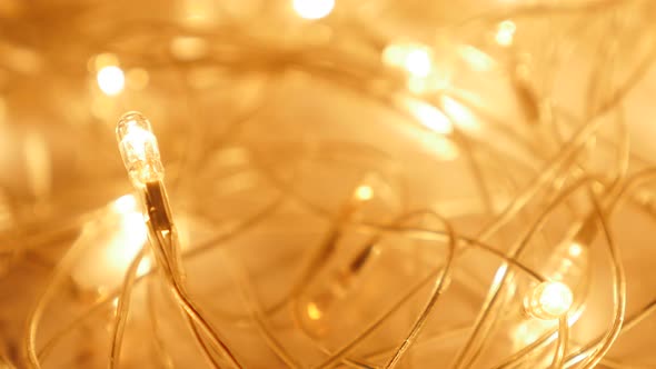 Golden Christmas sparkling background  with one bulb in focus 4K 2160p UHD footage - Glittering gold