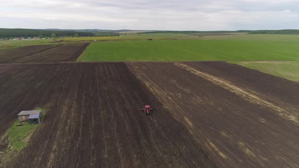 Tractor with Disc Harrows on the Farmland. Summer, cloudy 01