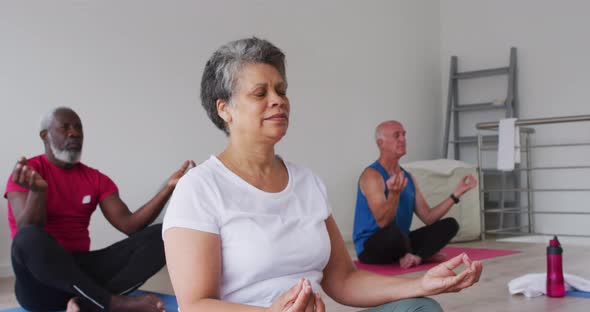 Diverse group of seniors taking part in meditation class