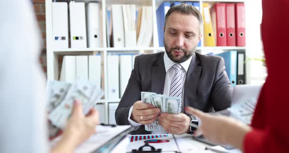 Team of Business People Counts Cash in Dollars