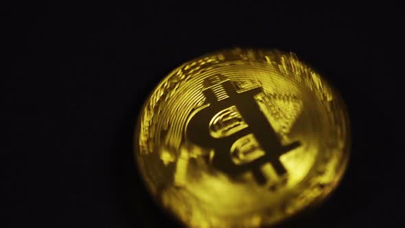 Cryptocurrency physical gold bitcoin on black background, new virtual money