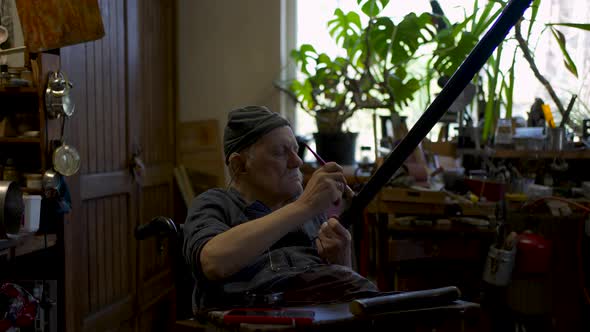 Elderly Male Master Works in His Workshop Restoring Japanese Sword