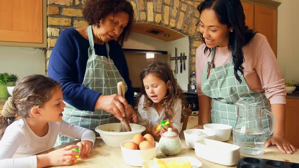 Siblings preparing food with family in kitchen 4k