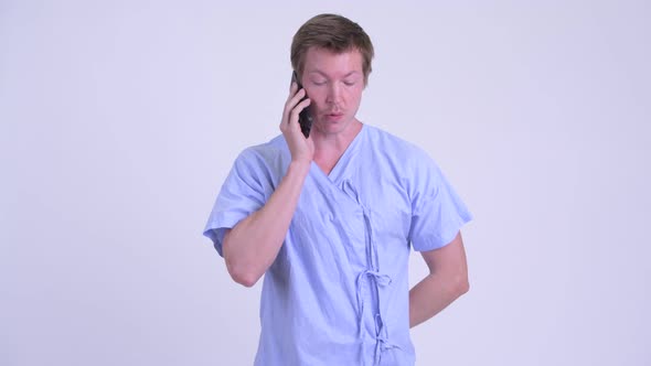 Young Stressed Man Patient Having Sore Throat While Talking on the Phone