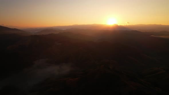 4K aerial view from a drone flying over the valley, fog in the morning.