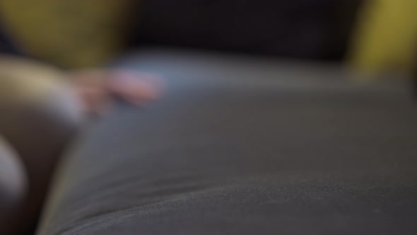 Closeup Female Hand Checking Couch Stiffness in Shop Showroom Indoors