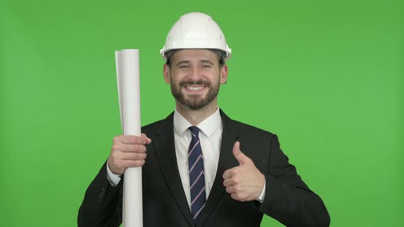 Happy Engineer with Blueprint Showing Thumbs Up Against Chroma Key