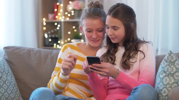 Happy Teenage Girls with Smartphone at Home