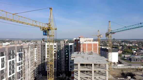 Building crane and monolituc building under construction. Construction site